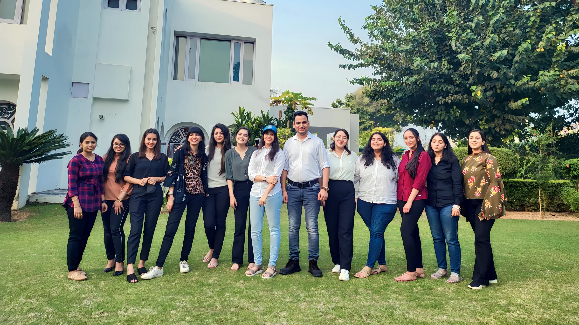 Lithvik Mukesh Sharma with colleagues on a lawn.