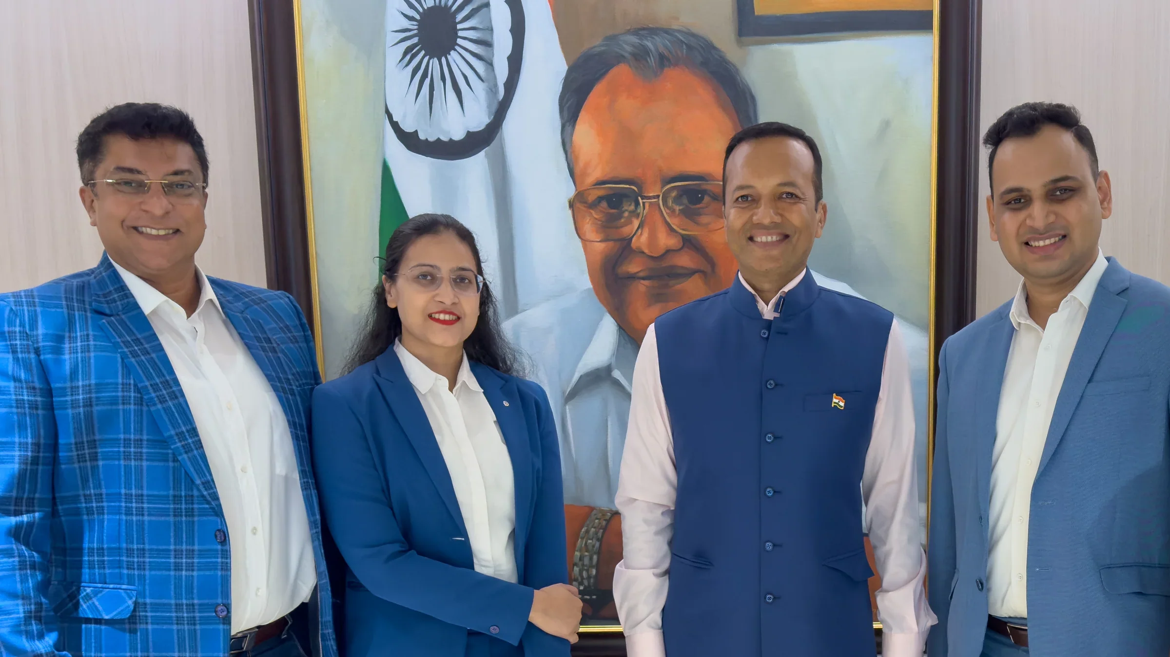 Lithvik Mukesh Sharma with four principals among paintings.