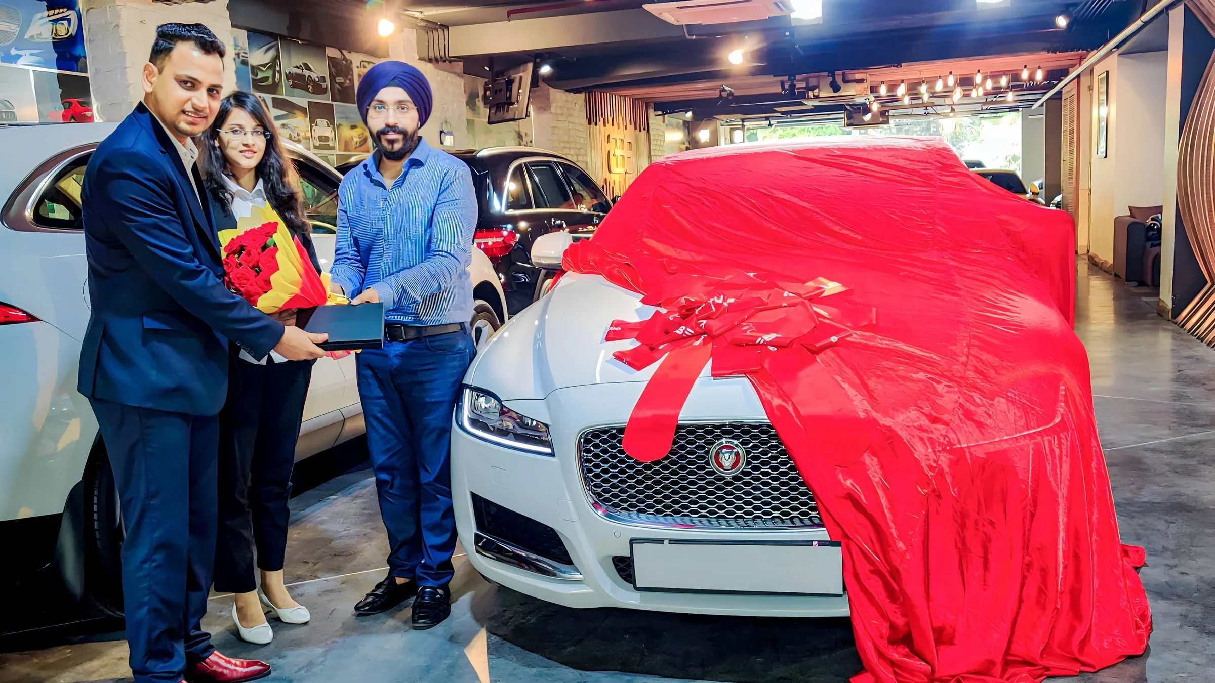 Lithvik Mukesh Sharma is photographed with Dr. Jyoti Kush and a Jaguar car
