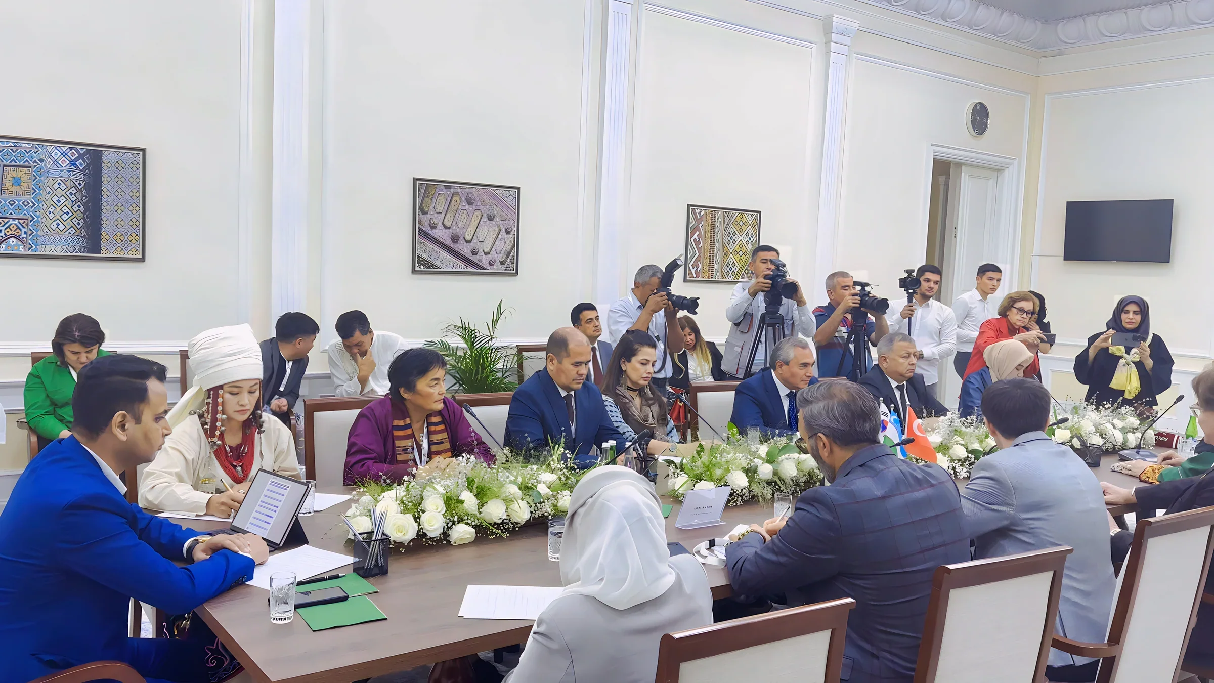 Lithvik Mukesh Sharma, Group CEO of CryptoMize, is photographed in a formal meeting at an ornate diplomatic setting in Uzbekistan. The ornate meeting room has cream-colored walls, white decorative molding