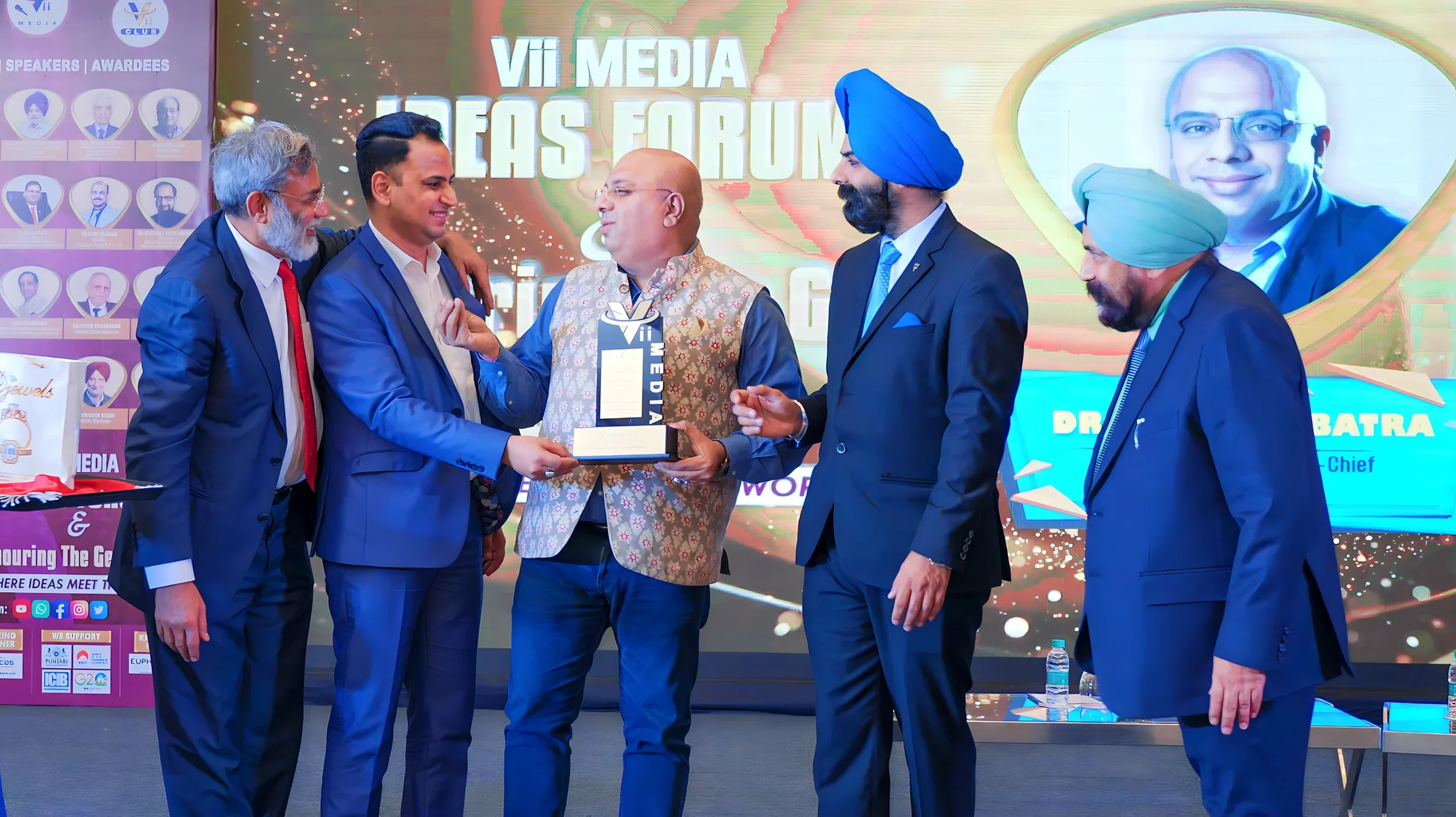 Lithvik Mukesh Sharma is photographed with Anurag Batra at a media event.