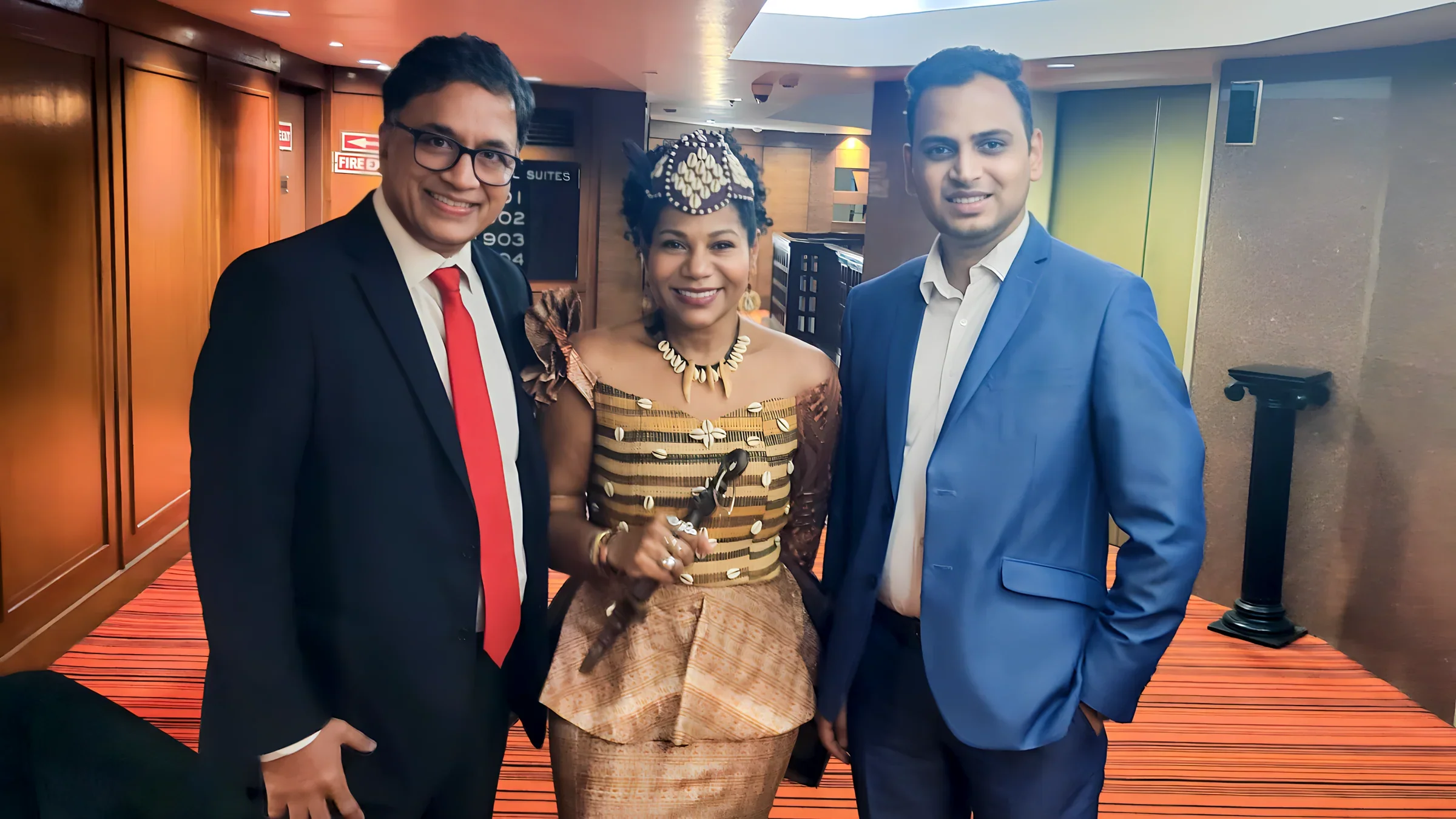 Lithvik Mukesh Sharma is photographed with Queen Diambi and co-attendees while hosting guests